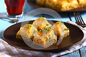 Traditional turkish baklava with tea on a blue background