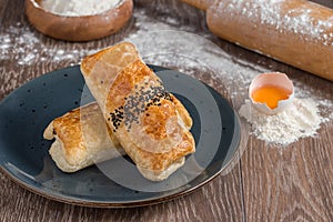 Traditional Turkish Borek or Turkish pastry with minced meat, cheese and spinac on wooden background
