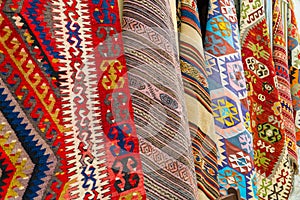 Traditional turkish carpets hanging on a wall on a street in old town Kaleichi, Antalya, Turkey photo
