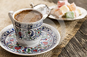 Traditional turkish coffee in porcelain cup with turkish delights