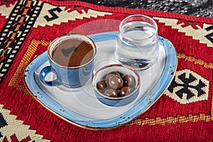 Traditional Turkish coffee in porcelain cup on wooden table. Anatolian Traditional Drink Hot and Delicious Turkish Coffee