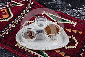 Traditional Turkish coffee in porcelain cup on wooden table. Anatolian Traditional Drink Hot and Delicious Turkish Coffee