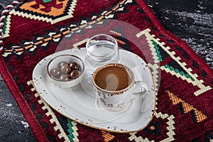 Traditional Turkish coffee in porcelain cup on wooden table. Anatolian Traditional Drink Hot and Delicious Turkish Coffee