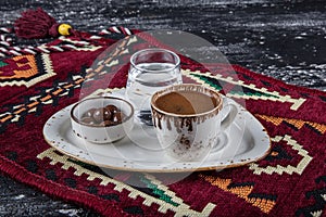 Traditional Turkish coffee in porcelain cup on wooden table. Anatolian Traditional Drink Hot and Delicious Turkish Coffee