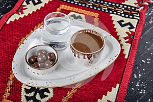 Traditional Turkish coffee in porcelain cup on wooden table. Anatolian Traditional Drink Hot and Delicious Turkish Coffee