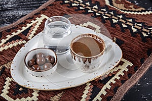 Traditional Turkish coffee in porcelain cup on wooden table. Anatolian Traditional Drink Hot and Delicious Turkish Coffee