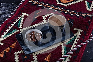 Traditional Turkish coffee in porcelain cup on wooden table. Anatolian Traditional Drink Hot and Delicious Turkish Coffee