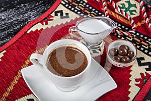 Traditional Turkish coffee in porcelain cup on wooden table. Anatolian Traditional Drink Hot and Delicious Turkish Coffee