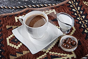 Traditional Turkish coffee in porcelain cup on wooden table. Anatolian Traditional Drink Hot and Delicious Turkish Coffee