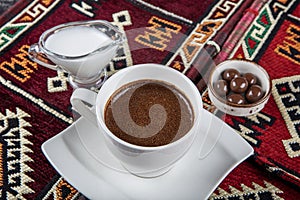 Traditional Turkish coffee in porcelain cup on wooden table. Anatolian Traditional Drink Hot and Delicious Turkish Coffee