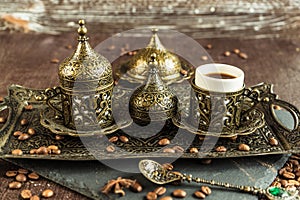Traditional turkish coffee in vintage cup in metal service, anise, roasted beans on brown background 4