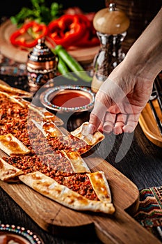 Traditional Turkish cuisine. Turkish pizza Pita with meat. Turk Pidesi or  Sucuk Pide. Beautiful serving dishes in the restaurant