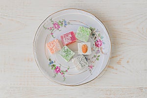Traditional turkish delight on a plate. Assorted Oriental sweets. Top view