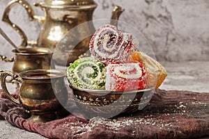Traditional Turkish delight with Turkish tea on gray background. Ramadan Kareem celebration concept. Fragrant Turkish tea and Turk