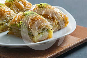 Traditional turkish dessert antep baklava with pistachio on white plate