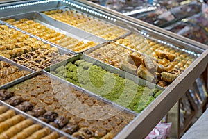 Traditional Turkish dessert baklawa in different flavors and styles in the Egyptian bazaar in Istanbul. Dessert shop at grand