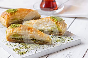 Traditional turkish dessert carrrot slice antep baklava with pistachio on rustic background photo