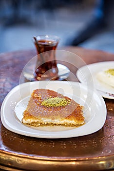 Traditional Turkish dessert Kunefe with Turkish Tea and ice cream.