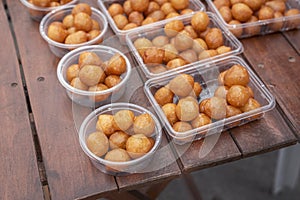 Traditional Turkish desserts on a plastic plates on a wooden table, close up