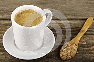 Traditional Turkish Dibek coffee in coffee cup on wooden table