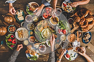 Traditional Turkish family breakfast table and people taking various food