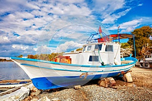 Traditional Turkish fishing boat ashore for maintenance