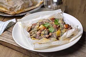 Traditional Turkish food; Meat with vegetables wrapped in greaseproof paper, kebab Turkish name; Sebzeli kagit kebabi