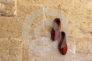 Traditional turkish handmade shoes Yemeni hanging on the wall.