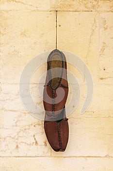 Traditional turkish handmade shoes Yemeni hanging on the wall.