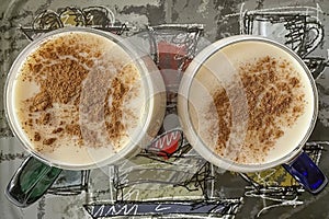 Traditional turkish hot drink sahlep or salep in white cup on brown background.