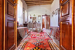 Traditional Turkish house interior with all authentic furniture and carpets on the floor. Light coming in through the side window