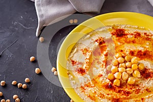 Traditional turkish hummus on a dark stone background