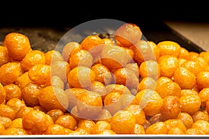 Traditional Turkish  Lokma dessert fryied in oil and sweetened with syrup photo