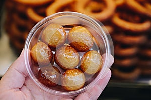 Traditional Turkish  Lokma dessert fryied in oil and sweetened with syrup photo