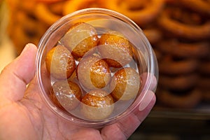 Traditional Turkish  Lokma dessert fryied in oil and sweetened with syrup photo