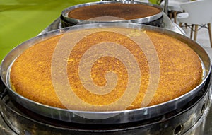 Traditional Turkish and Middle Eastern dessert in a big tray: Knafeh Turkish: Kunefe