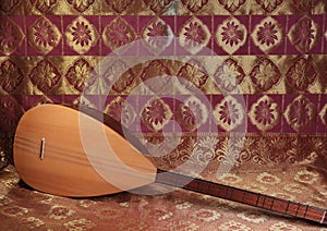 Traditional Turkish national musical instrument baglama saz on a dark red background. a magnificent century. The concept of Islam