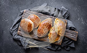 Traditional Turkish pastries pogaca with cheese on cutting board