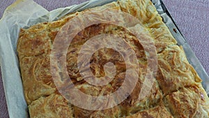 Traditional turkish pastry, freshly baked cheesy borek on a baking tray, borek surface has fried in the oven