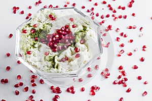 Traditional Turkish Ramadan Milky Dessert;Gullac in glass bowl with pomegranate seeds.