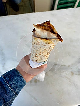 Traditional Turkish Street Food Lahmacun Holding in Hand