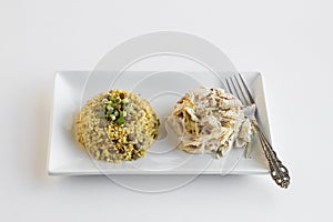Traditional Turkish Wheat `Bulgur` Pilaf with chicken in plate.