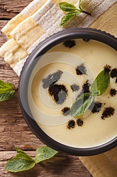 Traditional Turkish Yayla soup with mint and yogurt close up vertical top view