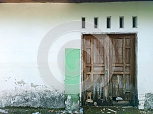 Traditional two wooden door with white wall