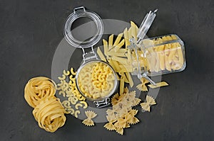 Traditional types and shapes of Italian pasta in glass jars