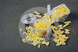 Traditional types and shapes of Italian pasta in glass jars