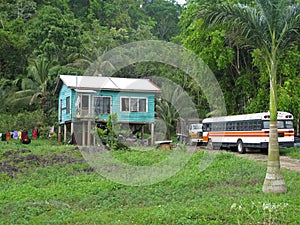 Traditional typical carribean house and old truck in Belize