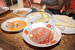 Traditional Ugandan food consisting of goat meat, cassava, potato, beans, maize meal, sweet potato, Uganda