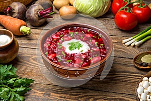 Traditional Ukrainian borscht with ingredients on a wooden rustic table. selected focus.