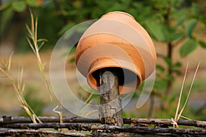 Traditional Ukrainian clay jug on wooden fence